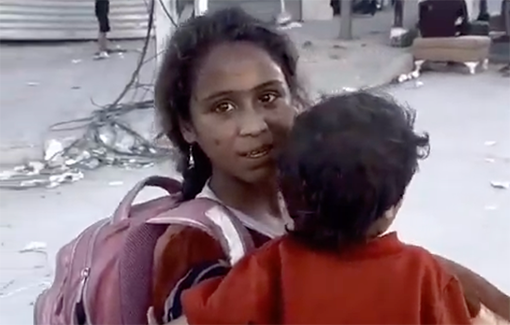 Thumbnail preview image for the video titled: A Palestinian girl breaks down as she carries her little brother to evacuate from central Gaza City