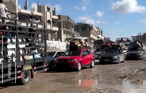 Thumbnail preview image for the video titled: Families leaving in Rafah, in cars on a muddy road, after Israel issued evaction orders and began bombing