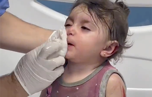 Thumbnail preview image for the video titled: Medical professional cleans up young girl after Israeli forces bombed her home in the Shati Refugee Camp