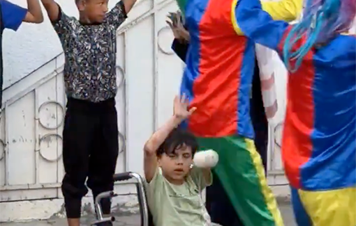 Thumbnail preview image for the video titled: Clowns entertain hungry displaced children at the Baptist Hospital in Gaza City on the first day of Eid