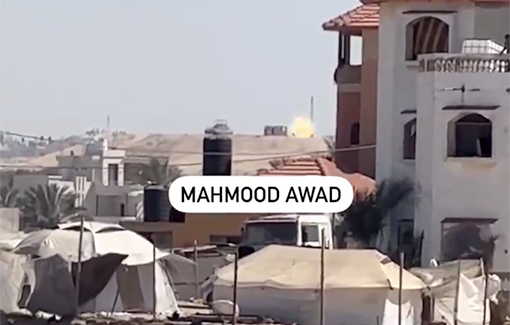 Thumbnail preview image for the video titled: Merkava tank on a hill fires at displaced refugeess living in tents in an Israeli-designated "safe area" in Rafah