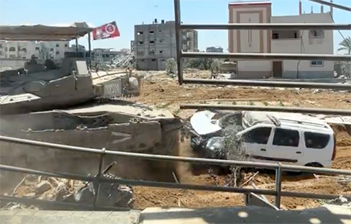 Thumbnail preview image for the video titled: An Israeli soldier posts a video from Rafah of a Merkava tank smashing into a minivan with the headline:  “POV: You are playing GTA in Rafah”