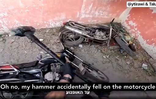 Thumbnail preview image for the video titled: An Israeli soldier from the 51st Battalion jokes as he destroys two motorcycles owned by displaced Palestinians