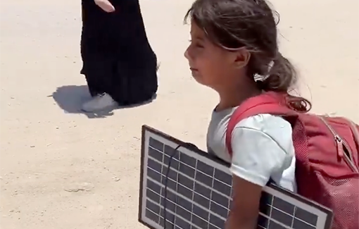 Thumbnail preview image for the video titled: A barefoot child carries a solar panel and backpack as she flees her home in home in Al-Shuja'iyya due to the IDF attacking her neighborhood