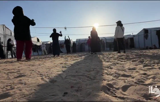 Thumbnail preview image for the video titled: Displaced girls play volleyball between tents in the Mawasi Khan Younis