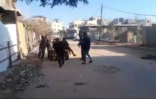 Thumbnail preview image for the video titled: Child holds her father injured by Israeli strike in front of Abu Tammam school