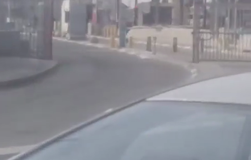 Thumbnail preview image for the video titled: A man lies on the ground after being shot at the Qalandiya checkpoint in Jerusalem.