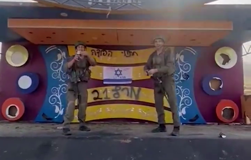 Thumbnail preview image for the video titled: Israeli soldiers celebrate the end of their military service atop a destroyed Palestinian wedding stall in Gaza