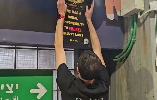 Thumbnail preview image for the video titled: Israeli refuznik are posting signs and handing out flyers at a Tel Aviv train station