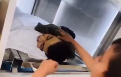 Thumbnail preview image for the video titled: The brother of the 13-y/o Muhammad Al-Amer in Jenin trying to warm his brother inside the morgue.