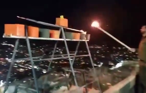 Thumbnail preview image for the video titled: Israeli soldiers desecrate holy Samaritan place by building a menorah from ammo boxes on top of Mount Gerizim