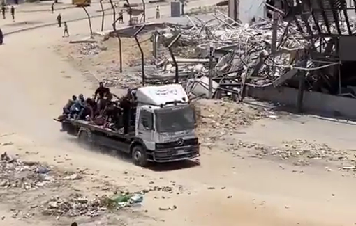 Thumbnail preview image for the video titled: A truck loaded with Palestinian civilian wounded crosses Sheikh Zayed Square