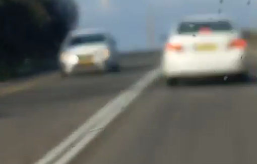 Thumbnail preview image for the video titled: An Israeli settler pulled out a pistol from his car window and threatened Palestinian vehicles on Farsh Al-Hawa Road in Hebron