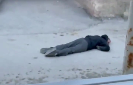 Thumbnail preview image for the video titled: Injured youth lying on the street as Israeli troops threaten rescuers