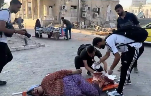 Thumbnail preview image for the video titled: Injured woman treated in the street as the IDF forces the evacuation of Al-Ahli Hospital