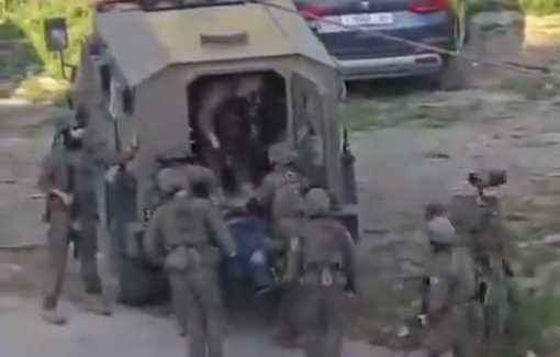 Thumbnail preview image for the video titled: Israeli forces abducting the body of Ismail Abu Ghali before desecrated it in a bulldozer