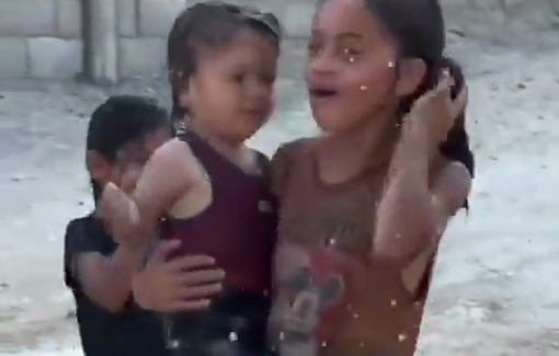 Thumbnail preview image for the video titled: Palestinian children trying to cool themselves amid the blistering summer heat in Gaza