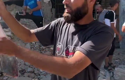 Thumbnail preview image for the video titled: Man showing human remains in bag after IDF airstrike on Al-Zahra school