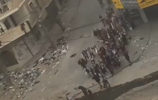 Thumbnail preview image for the video titled: Women and children waving a white flag are targeted by an IDF sniper and one of the women is killed