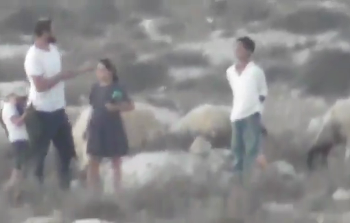 Thumbnail preview image for the video titled: Settler hands his rifle to a toddler aiming at Palestinian village