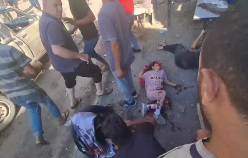 Thumbnail preview image for the video titled: Deir al-Balah market strike-wounded children and mother lying on the floor