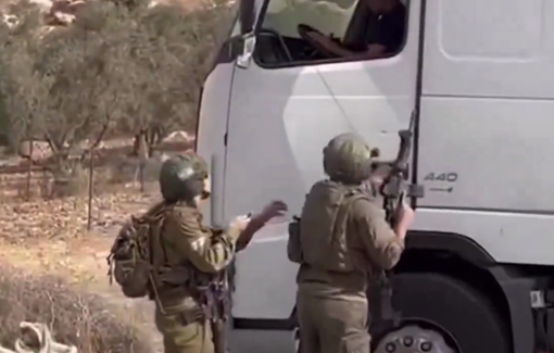 Thumbnail preview image for the video titled: Israeli soldiers threaten driver, shoot out truck tire at checkpoint