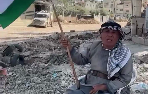 Thumbnail preview image for the video titled: A Palestinian holds the flag of Palestine in front of the Israeli army storming Tulkram