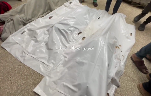 Thumbnail preview image for the video titled: Shrouded bodies on the hospital floor after IDF helicopter bombed a tent