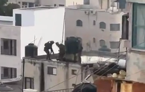 Thumbnail preview image for the video titled: Soldiers throw bodies of Palestinians off a roof in Qabatiya