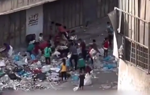 Thumbnail preview image for the video titled: Children in northern Gaza scavenging through trash for leftover food