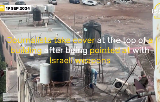 Thumbnail preview image for the video titled: Journalists seek cover atop a building after being targeted with Israeli weapons during a raid in Qabatiya