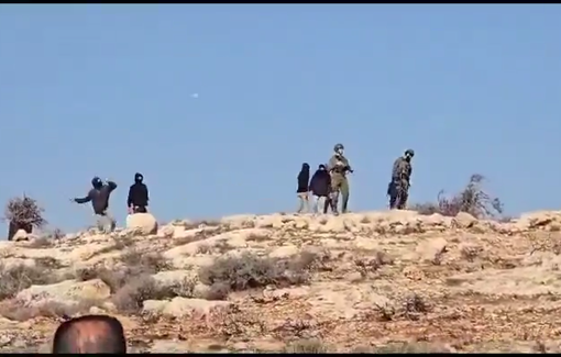 Thumbnail preview image for the video titled: Israeli settlers throwing stones at Palestinians with the accompaniment of a soldier.